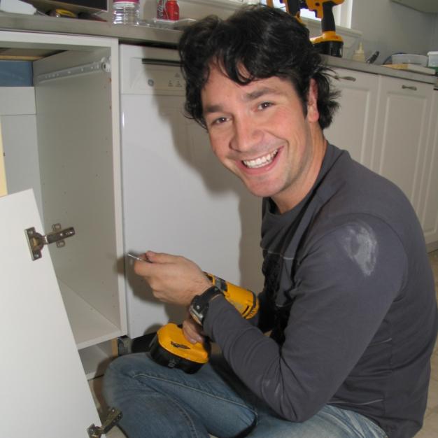 Tyler working on the kitchen cabinets  